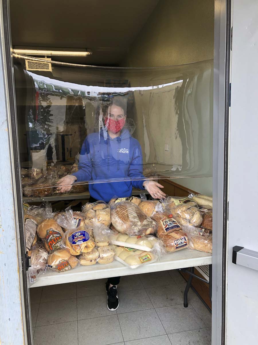 Bread loaves are given out to the homeless and those in need at the Share location in Vancouver. Clear Plastic shields protect servers and customers. Photo courtesy of Share Vancouver