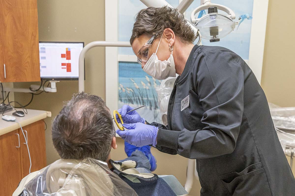 Seen here is Smiles Dental dental assistant Nicole Di Pietra preparing to take an x-ray of a patient. Photo by Mike Schultz