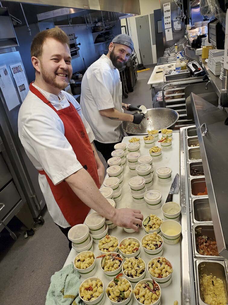 Twigs Bistro Executive Chef and Sous Chef, Spencer Spencer (back) Galbraith and Teagan Moore (front) prepare meals for donation to area hospitals as part of the “Buy a Meal, Give a Meal” program. Photo courtesy of Twigs Bistro