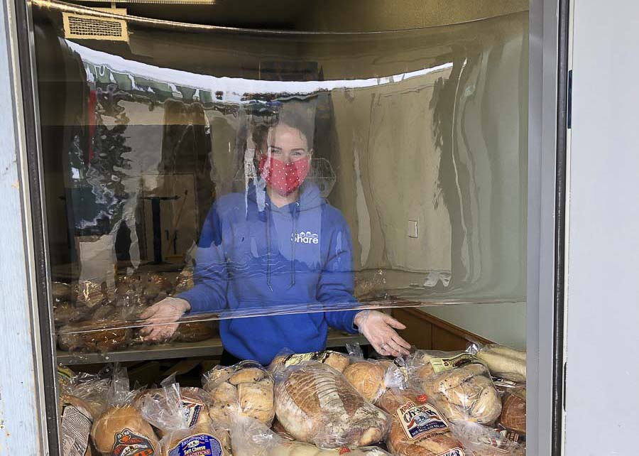 Bread loaves of bread are given out to the homeless and those in need at the Share location in Vancouver. Clear Plastic shields protect servers and customers. Photo courtesy of Share Vancouver