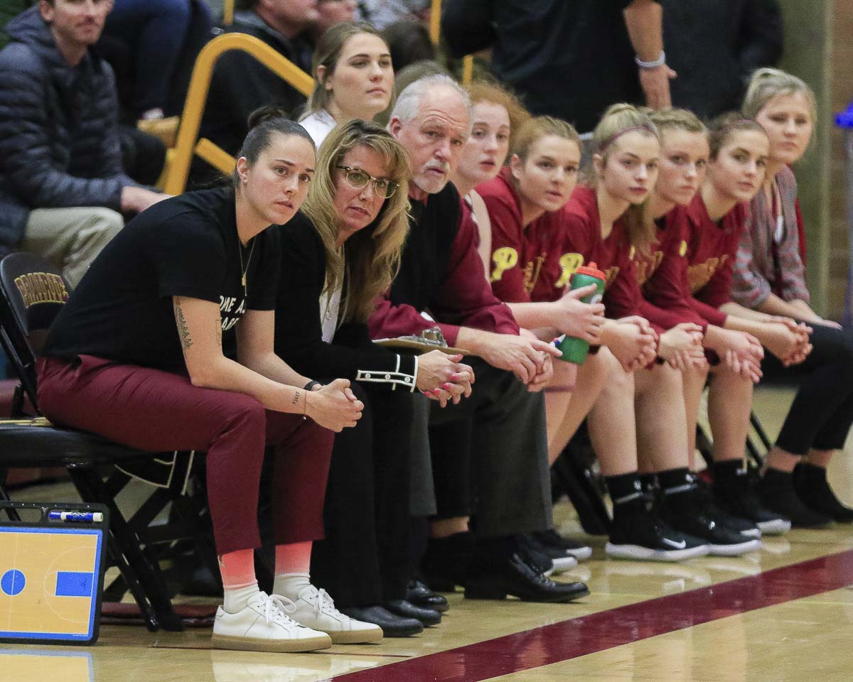 Hala Corral, second from left, was the head coach of Prairie girls basketball for four years, leading the Falcons to four state tournament appearances and one state title. Photo by Mike Schultz