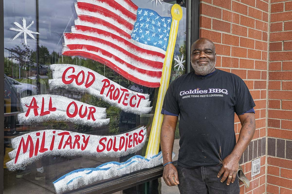Charles Bibens is proud to show off his family’s passions at his restaurant. Signage that says Jesus is the Reason and a salute to military and law enforcement decorate Goldies Texas Style BBQ. Photo by Mike Schultz