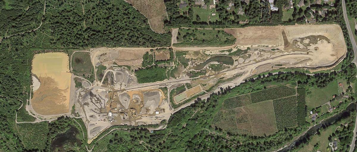 The Cadman Lewisville gravel pit as seen from above via Google Earth. The holding pond and related dam or dike can be seen off to the right. Photo by Google Maps