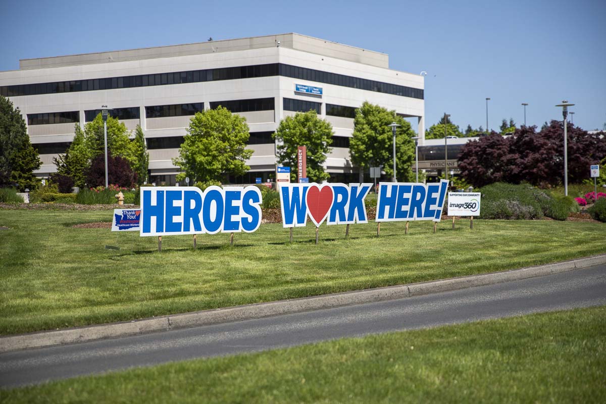 The “Heroes Work Here” sign out front of PeaceHealth Southwest Medical Center was the first to be installed by Image360. Photo by Jacob Granneman