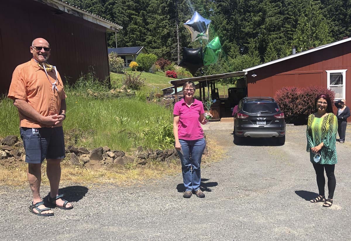 Superintendent Michael Green (left) and Assistant Superintendent Asha Riley (right) visited each of the retirees at their homes, including Annette Kirby (pictured here). Photo courtesy of Woodland Public Schools