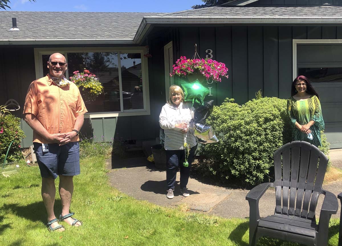 Superintendent Michael Green (left) and Assistant Superintendent Asha Riley (right) visited each of the retirees at their homes, including Karen Ward (pictured here). Photo courtesy of Woodland Public Schools
