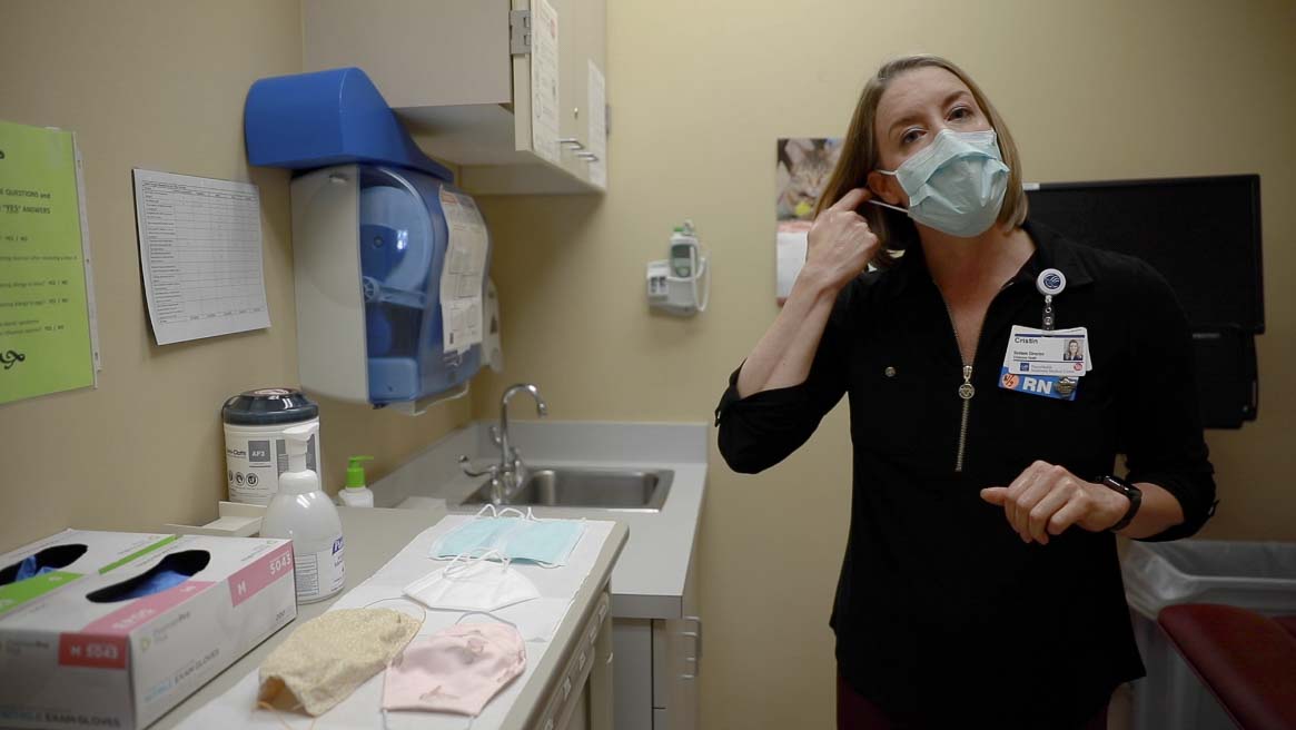 PeaceHealth Southwest Medical Center system director for employee health, Cristin Connor, is seen here demonstrating the proper method for removing a face mask. Photo by Jacob Granneman