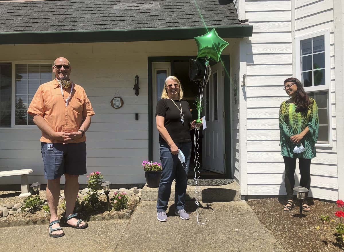 Superintendent Michael Green (left) and Assistant Superintendent Asha Riley (right) visited each of the retirees at their homes, including Sandra George (pictured here). Photo courtesy of Woodland Public Schools