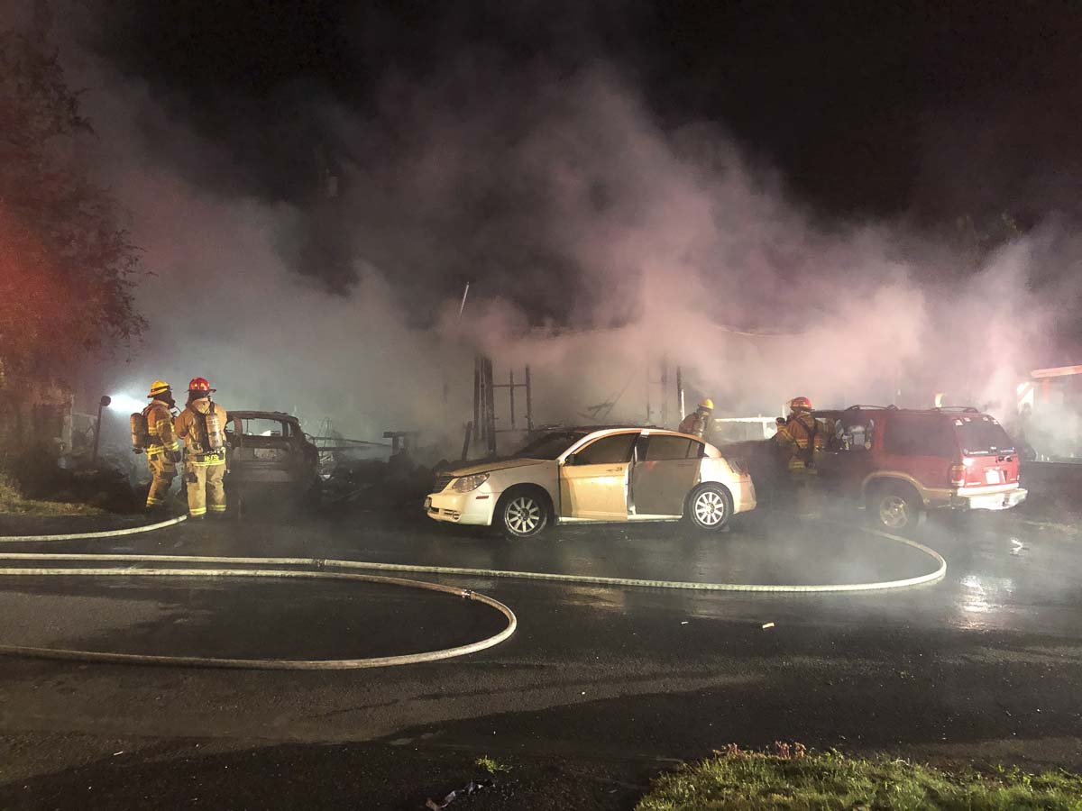 Clark County Fire & Rescue crews work to extinguish vehicles and a mobile home early Friday morning in Ridgefield. Photo courtesy of Clark County Fire & Rescue