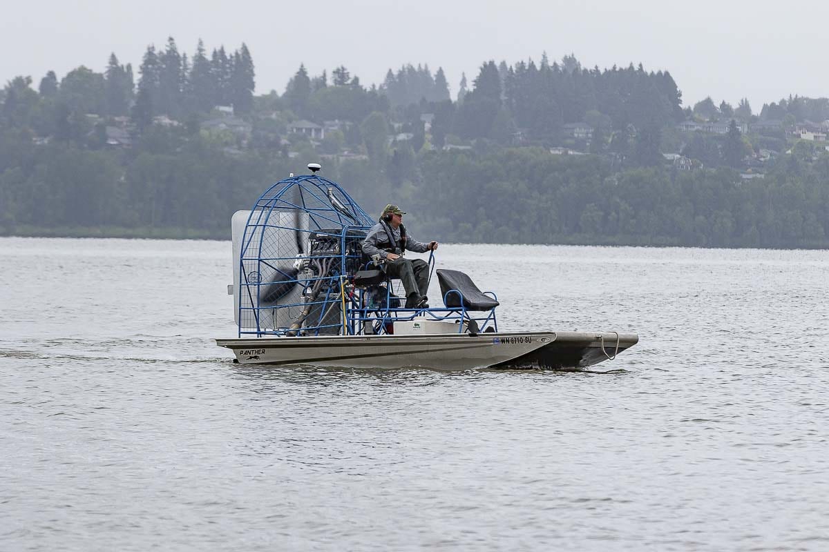 Applicator Terry McNabb of Bellingham-based AquaTechnex LLC is shown here on July 7 applying treatment to eradicate Eurasian Milfoil at Vancouver Lake. Photo by Mike Schultz