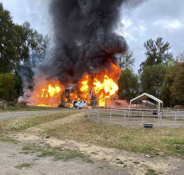 The fully involved barn is shown here as firefighters prepare to apply water. Photo courtesy of Jennifer Fowler
