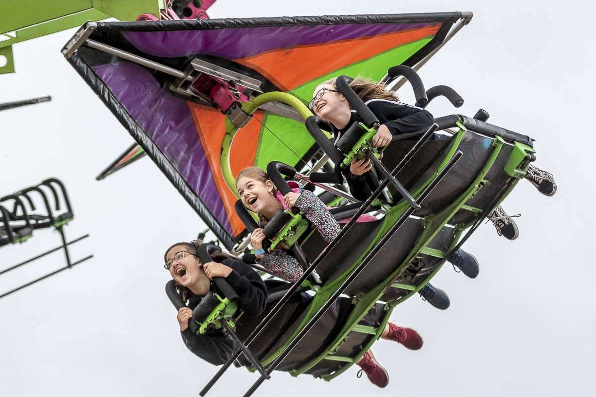 Molly Walther, Carolyn Howard, and Maggie Hart had a blast last year on the rides at Clark County Fair. Fairgoers will have to wait another year to return to the fair. Photo by Mike Schultz