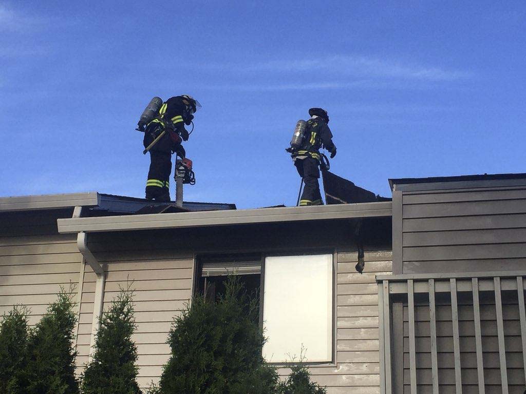 A Vancouver ladder truck crew went to the roof to reach an area of the attic that was difficult to access from below. Photo courtesy of Vancouver Fire Department