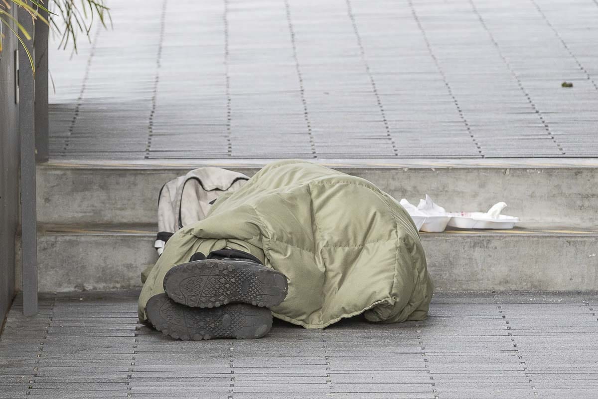 A homeless resident sleeps outside of the Clark County Public Services Building in March. Photo by Mike Schultz
