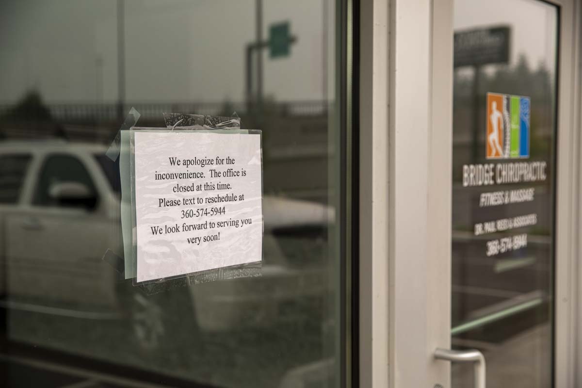 A sign on Bridge Chiropractic in Salmon Creek says the business is temporarily closed. Clark County Public Health says an employee tested positive for COVID-19. Photo by Jacob Grannmenan