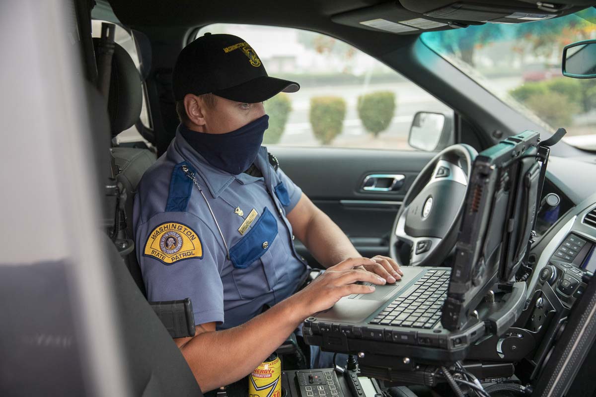 Trooper Tyler Preston searches state databases for the license of a man suspected of driving distracted near I-205 and Mill Plain. Photo by Jacob Granneman
