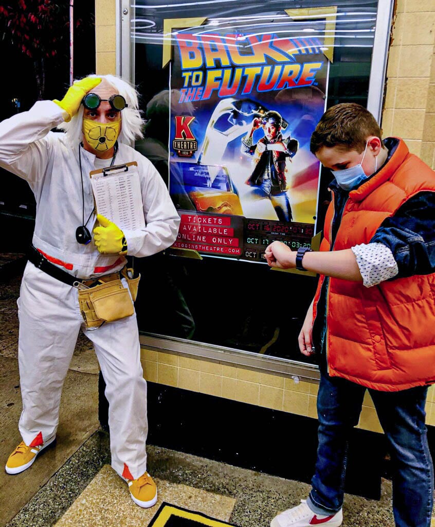 Kiggins Theatre owner Dan Wyatt, as Doc Brown, and his son Tucker, as Marty McFly, welcomed movie goers to the reopening of Kiggins Theater. Rumor has it Doc Brown will return this weekend with Back to the Future Part II. Photo courtesy Dan Wyatt