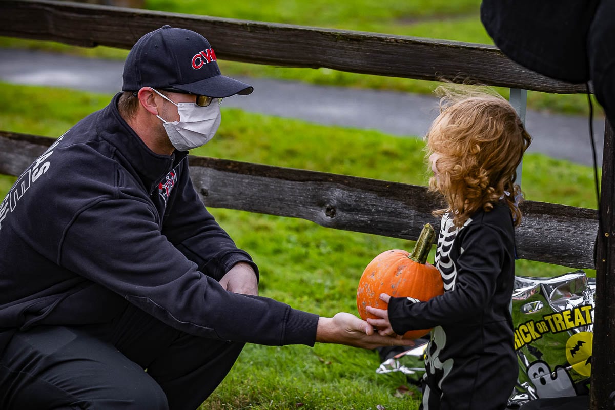Camas-Washougal firefighter Steve Camden is shown heer handing out pumpkins during the festival. Photo by Mike Schultz