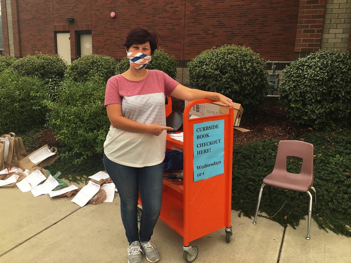 Union Ridge Elementary School librarian, Jubilee Roth, is ready to hand out books with the new Curbside Checkout program. Photo courtesy of Ridgefield School District