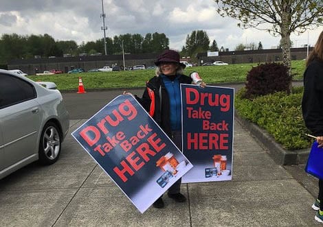 Volunteers wait outside a drug take back event in 2019. File photo