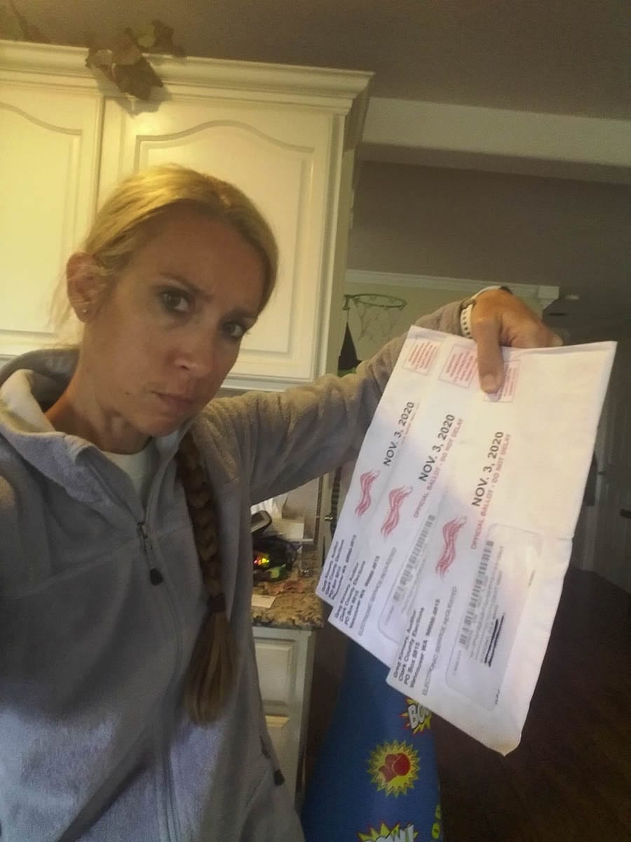 Julie Bonaci Scordino holds the three election ballots delivered by Camas police Sunday morning. Vandals broke into their neighborhood mailbox early Sunday morning, stealing mail, including the ballots. Photo Julie Bonaci Scordino