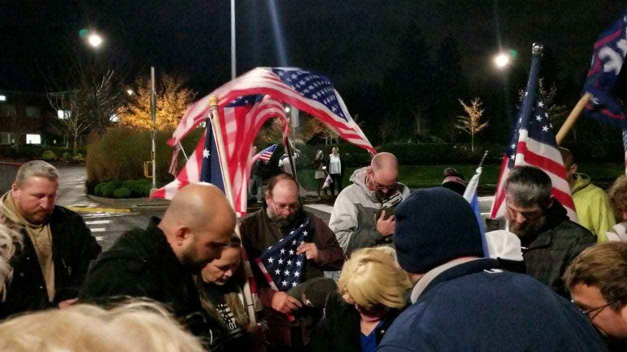 Friends gather outside a local hospital, saying the Pledge of Allegiance and a prayer for their friend, Dave Alt. Photo by John Ley