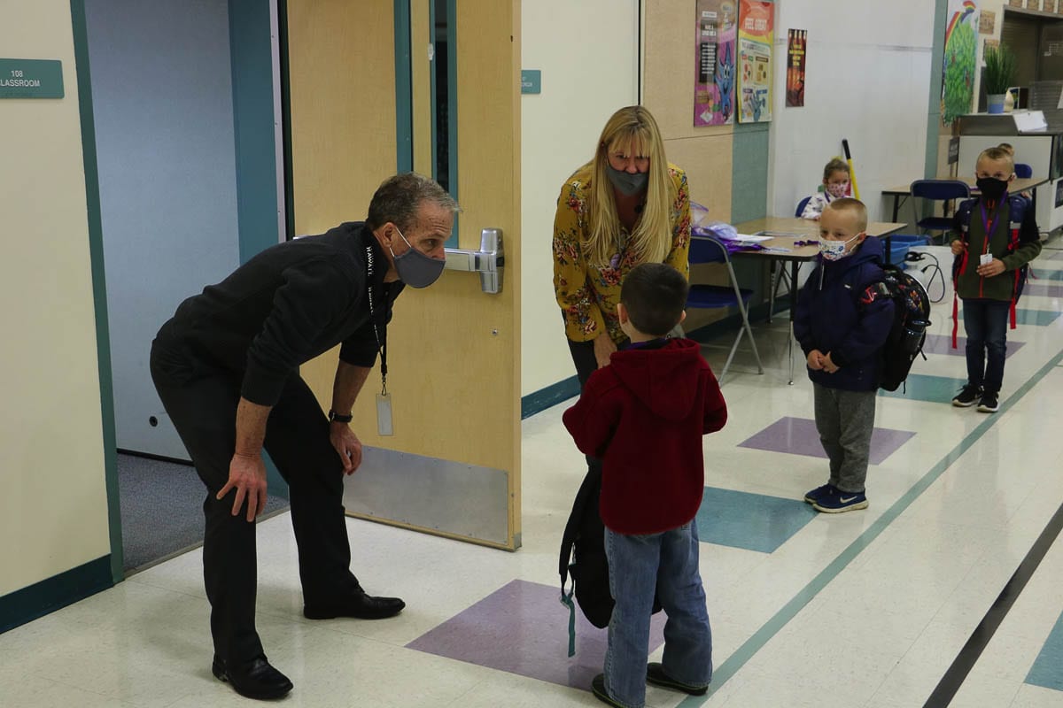 Battle Ground Deputy Superintendent Denny Waters greets kindergarten students on their first day back in classrooms last November. Photo courtesy Battle Ground Public Schools