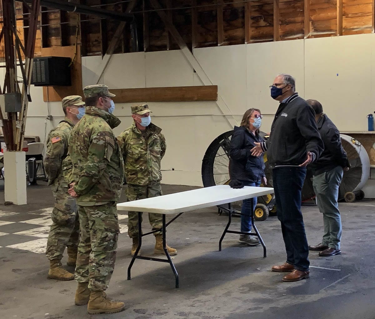 Gov. Jay Inslee talks with members of the Washington National Guard while visiting a mass vaccination site at the Clark County Fairgrounds on Thursday. Photo courtesy Office of Governor Jay Inslee