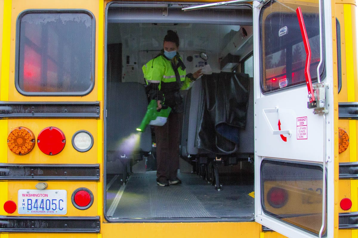 Mary Martin, a KWRL driver, uses a special electrostatic sprayer to clean buses using fog cleanser and static electricity. Photo courtesy of Woodland Public Schools