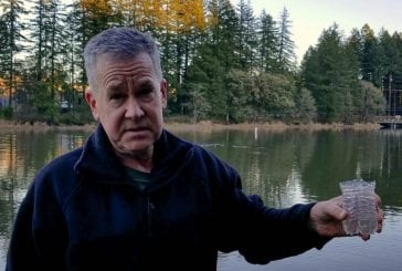 County Councilor Gary Medvigy works to clean up Lacamas Lake water
