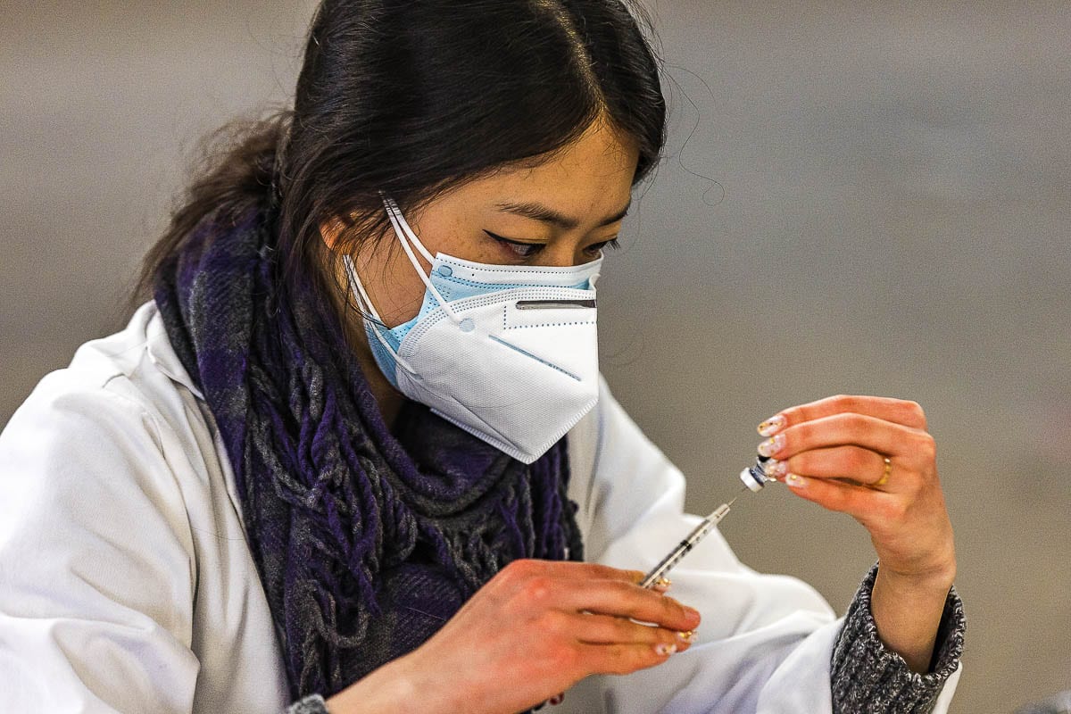 Safeway Pharmacist Jennifer Park draws a dose of COVID-19 vaccine from a Pfizer-BioNTech bottle at the Clark County Fairgrounds on Tuesday. Photo by Mike Schultz