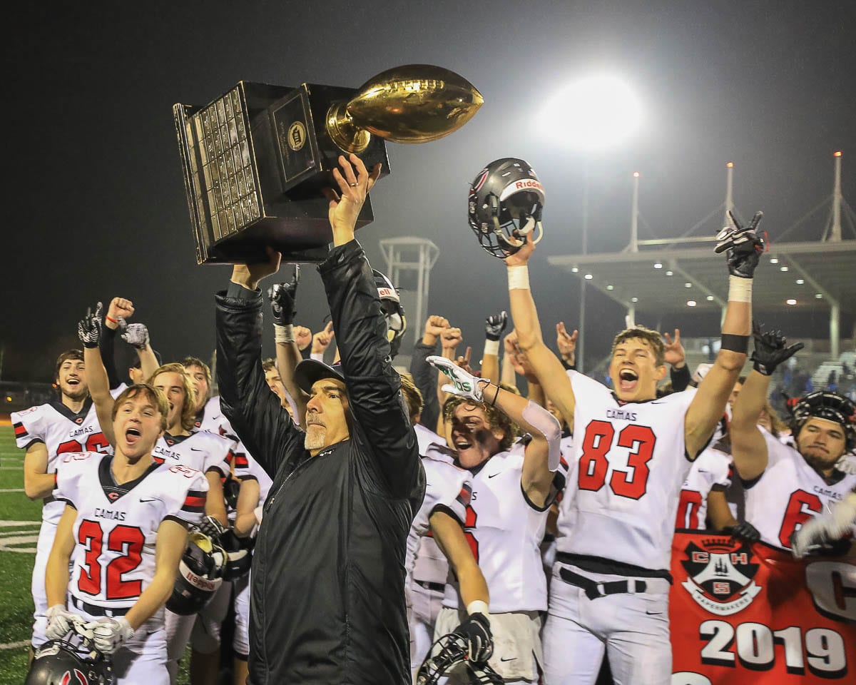 Camas coach Jon Eagle hoists the state championship trophy after the Papermakers won it all in December 2019. Football season is back after a long offseason. The 4A and 3A GSHL will start playing Feb. 26. Photo by Mike Schultz