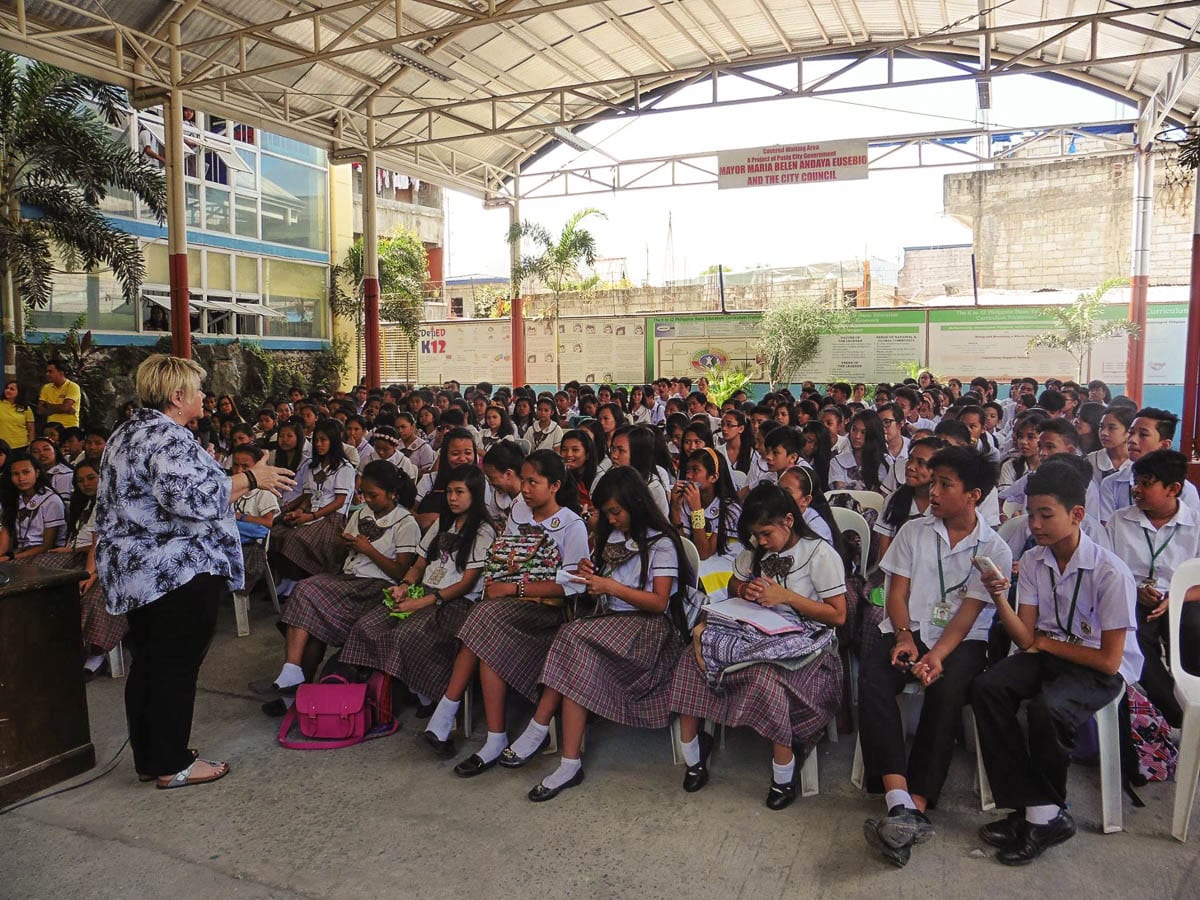 Dr. Cyndi Romine speaks to a group of children in the Philippines during an educational event aimed at helping young people recognize dangerous situations. Photo courtesy of Called To Rescue