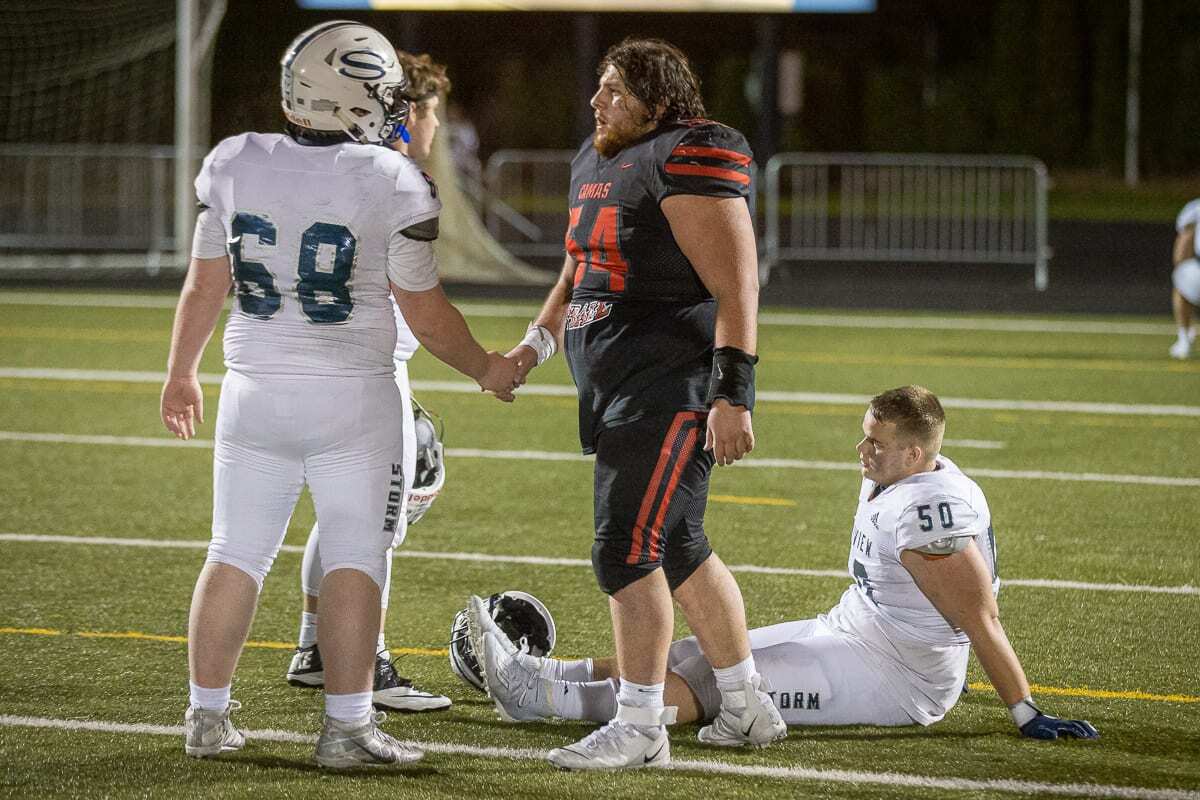 Camas senior Robert Silva (54) shakes hands with Skyview’s Trenton Miller after the two teams put on a show Tuesday night. Camas prevailed 38-31 in double overtime. Photo by Mike Schultz