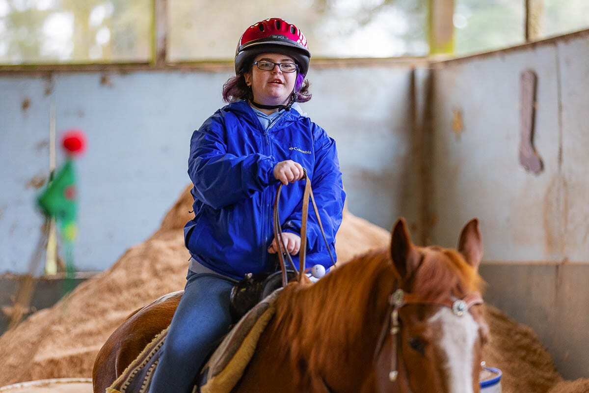 Emily Van Houten, who has special needs, is a regular rider at Healing Winds Therapeutic Riding Center. Photo by Mike Schultz