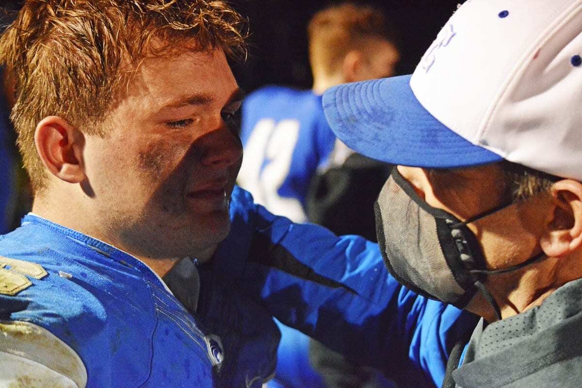 La Center head football coach John Lambert hugs his son, Tom, after their final high school football game together. “Life moves pretty fast,” Lambert wrote on Twitter with pictures of Tom growing up. “You don’t stop and look around once in a while, you could miss it.” Photo by Dan Trujillo