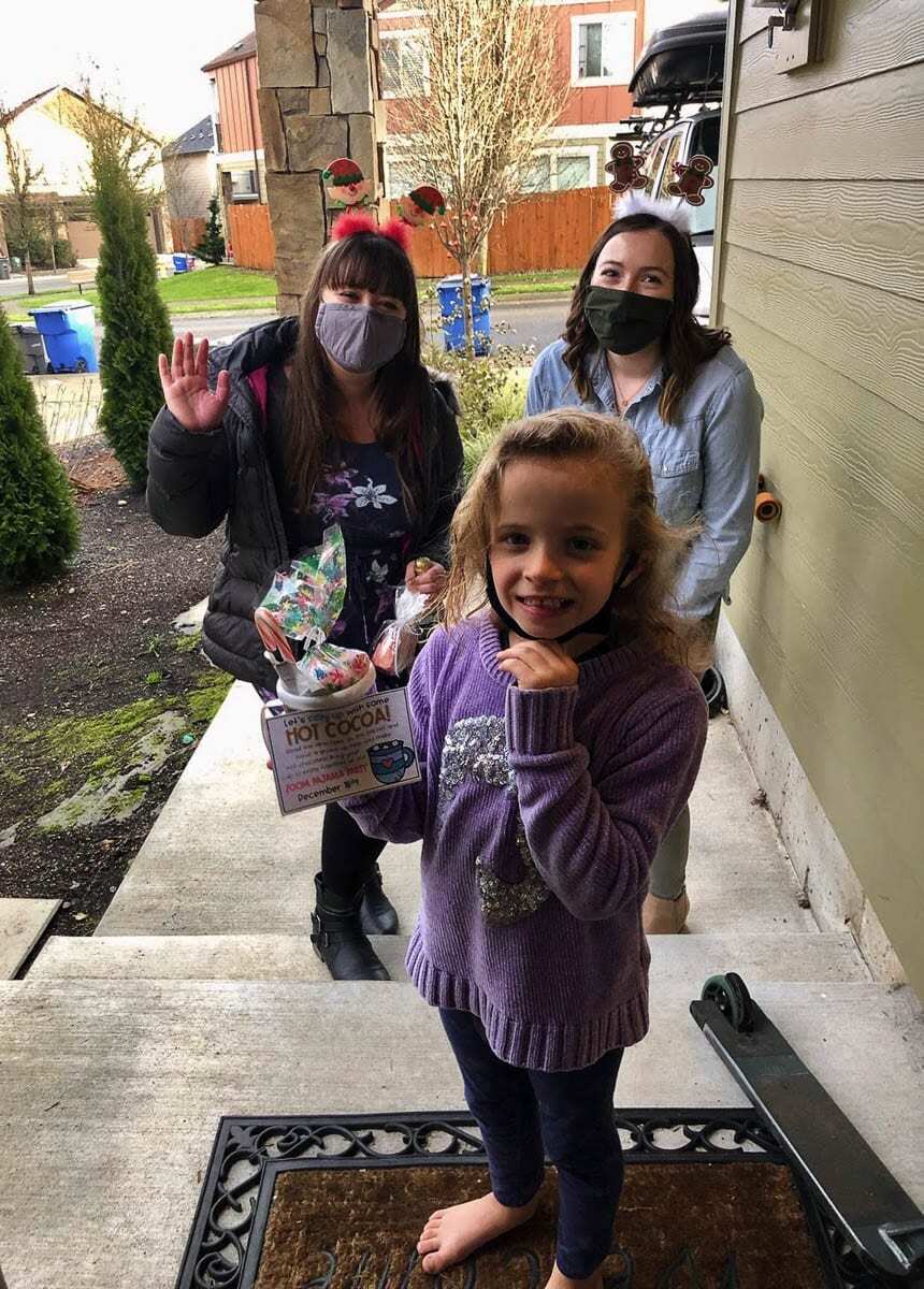 Teacher Shandel Oderman (on the right) and student teacher Briana Lewellen drop off a weekly learning packet for Timber Engstrom -- including a special treat and an invitation to the class Zoom Pajama Party. Photo courtesy of Ridgefield School District
