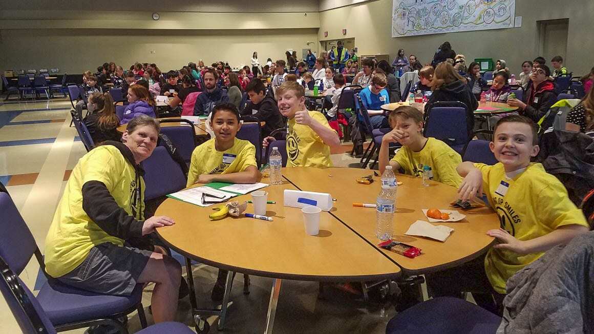 Custodian Nancy Stoy interacts with students during lunch at Lacamas Lake Elementary. Although life at the school has changed since this picture was taken, Stoy’s message to protect the environment has gotten stronger. Photo courtesy of Michelle Sanow.
