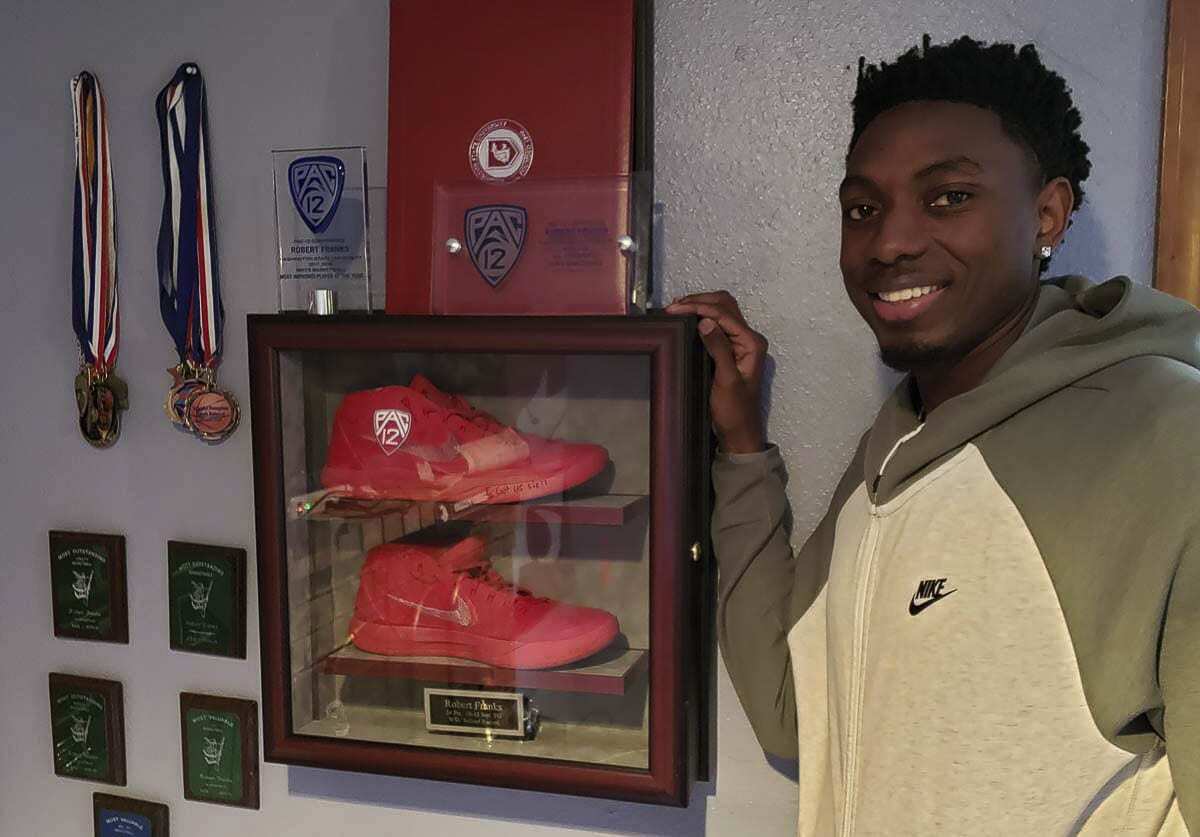 Robert Franks, shown here in 2019, next to the shoes he wore when he made 10 3-pointers in a game for Washington State. The Vancouver man now plays in the NBA for the Orlando Magic. Photo by Paul Valencia
