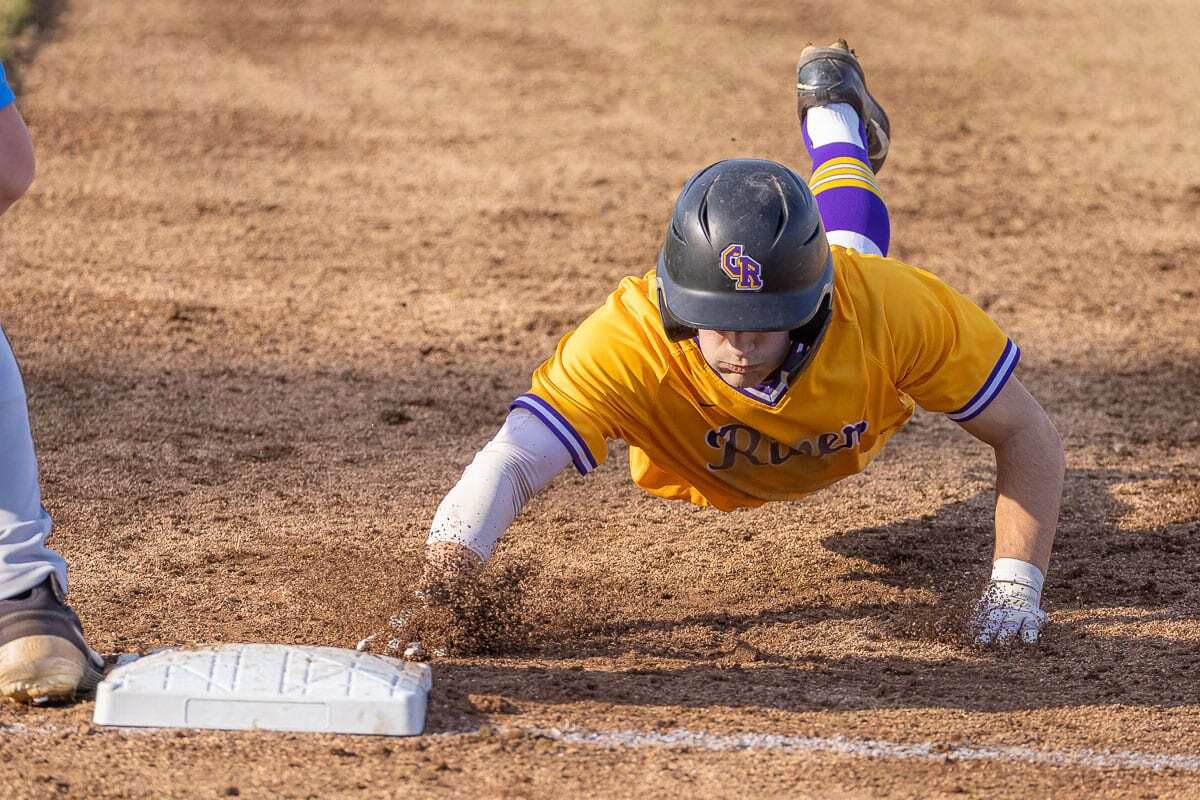 Nick Alder slides safely back to first base Wednesday during Columbia River’s win over Hockinson. Photo by Mike Schultz