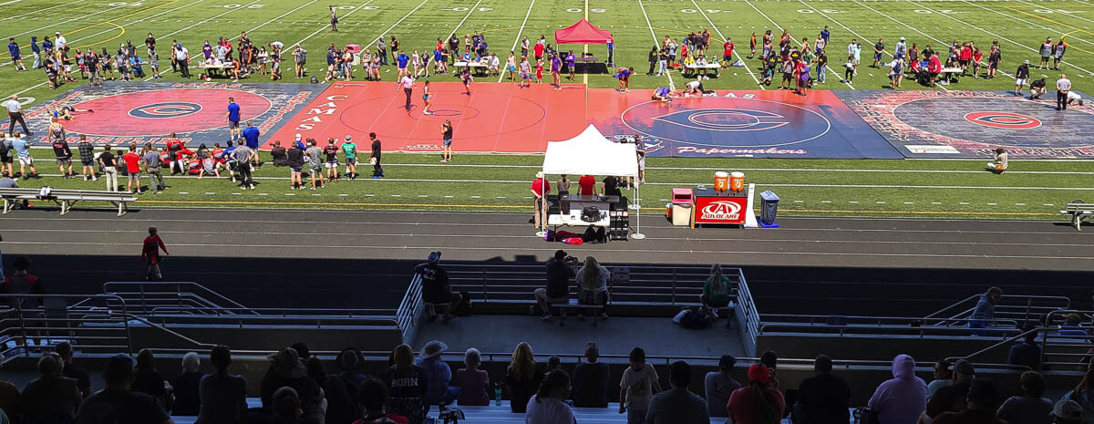Camas High School brought four wrestling mats to Doc Harris Stadium, turning high school wrestling into an outdoor sport this season. Photo by Paul Valencia