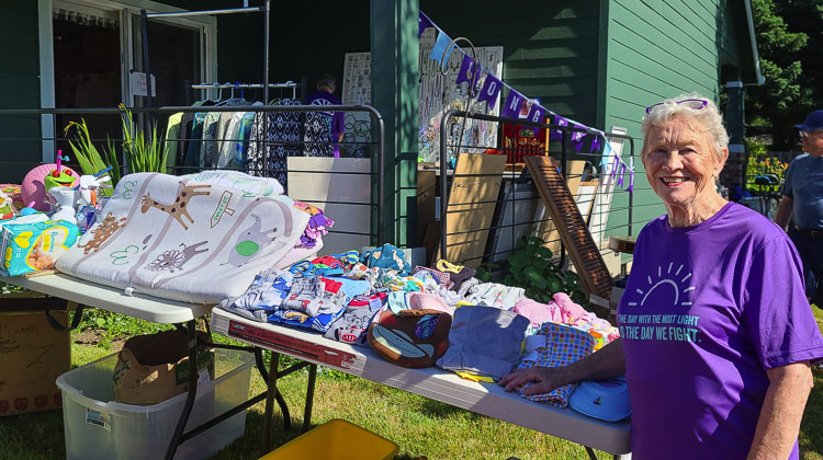 Colleen Hoss is holding a “yard sale on steroids,” a fundraiser for Alzheimer’s research. It is part of The Longest Day campaign. Her shirt reads: The day with the most light is the day we fight. Photo by Paul Valencia