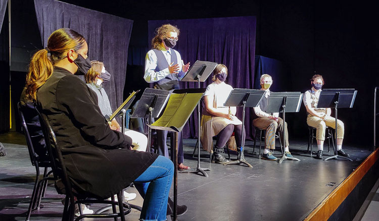 Battle Ground High School senior Andrew Ovall (center) reads part of an original play he co-wrote with junior Lorelei Hunsaker. Photo courtesy of Battle Ground School District