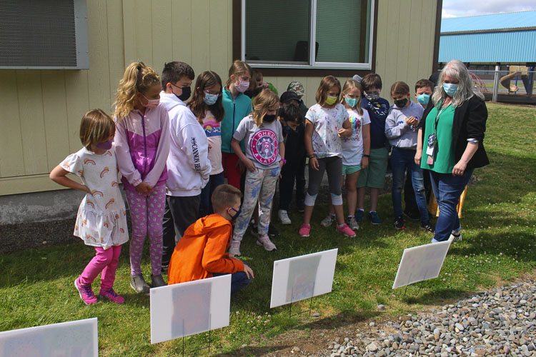 The class read the story with South Ridge Elementary School librarian Emily Crawford by following the pages posted along the path. Photo courtesy of Ridgefield School District