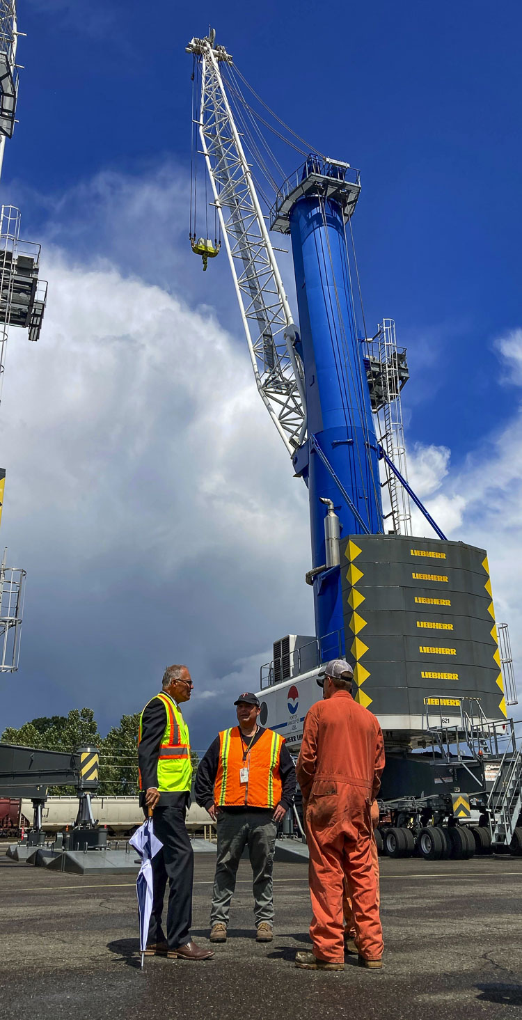 After a brief rain shower, the governor and port staff walked around the Vestas blades and met briefly with two of the port’s Liebherr crane mechanics, where he learned about the intricacies of unloading the delicate but large blades from cargo ships. Photo courtesy of Port of Vancouver USA