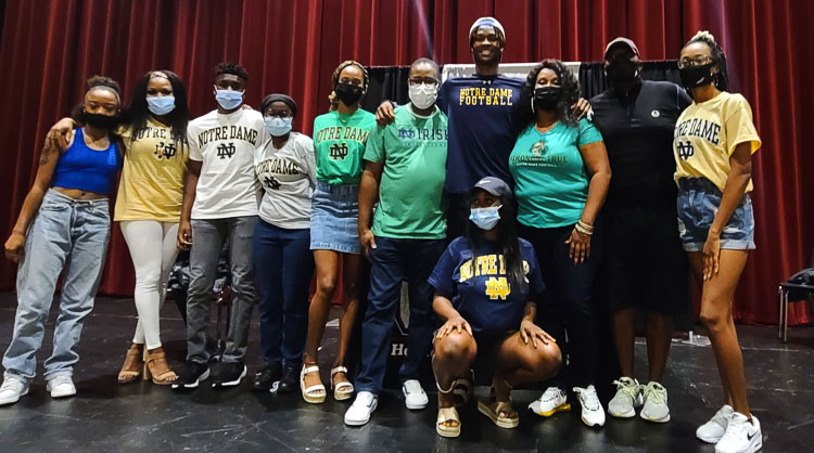 Tobias Merriweather, the tall one, stands proud with family members Wednesday after he announced his intention to sign with the University of Notre Dame to play football for the Fighting Irish. Photo by Paul Valencia