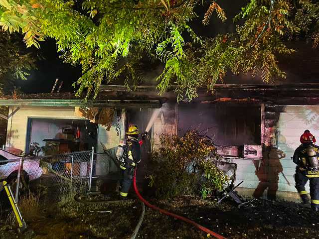 An engine crew from the Vancouver Fire Department extinguished hotspots at a fatality house fire Saturday morning. Photo courtesy Vancouver Fire Department