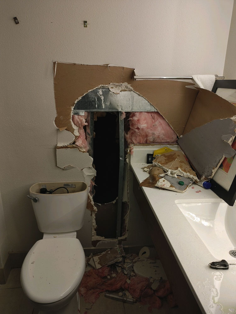 Anatoly Kutsar and Rachel Kaz-Clark cut a hole through the bathroom wall of their hotel room in an attempt to elude law enforcement in Florida. Kutsar was wanted for crimes throughout the country, including here in Southwest Washington. Photo courtesy Richard Hassler, Regan Bail Bonds.