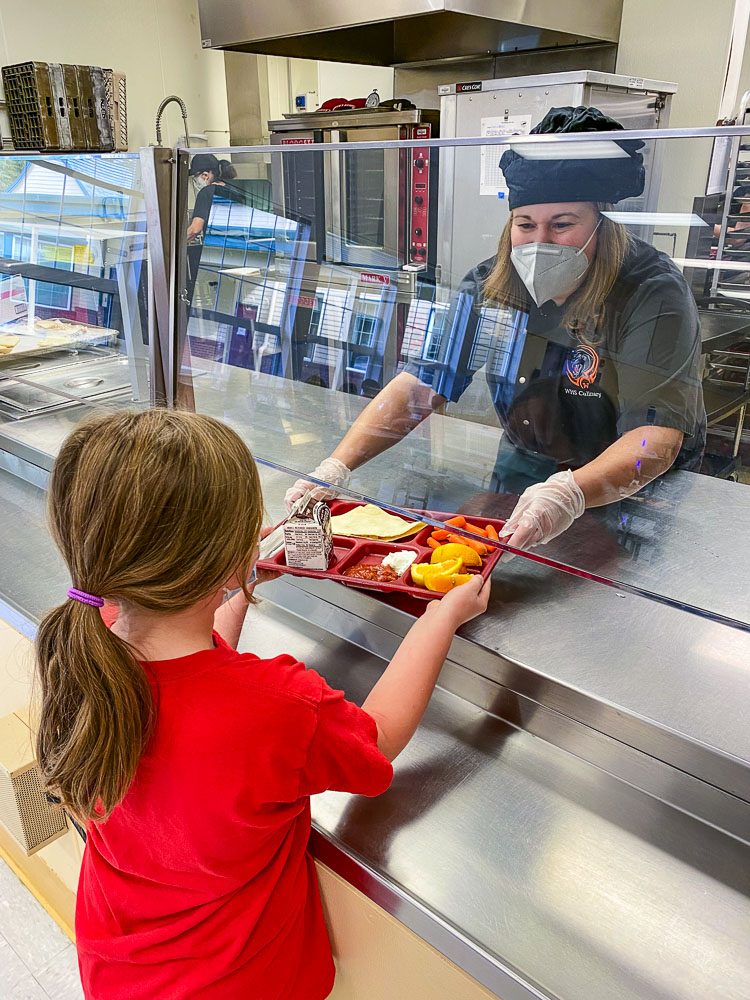 A student receives lunch from Chef Wendy Morrill at Hathaway Elementary School recently. Photo courtesy Washougal School District