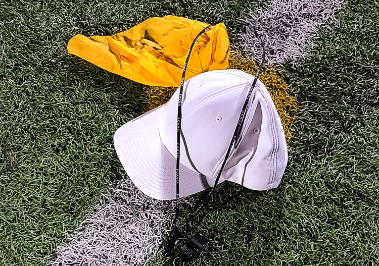Rick Gilbert left his hat, flag, and whistle on the 50-yard line on Thursday after he officiated a varsity high school football game for the last time. He has been an official for 36 seasons. Photo by Paul Valencia